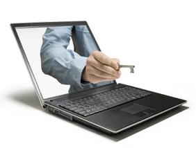 Image of laptop with hand holding a skeleton key extending outwards through the display.